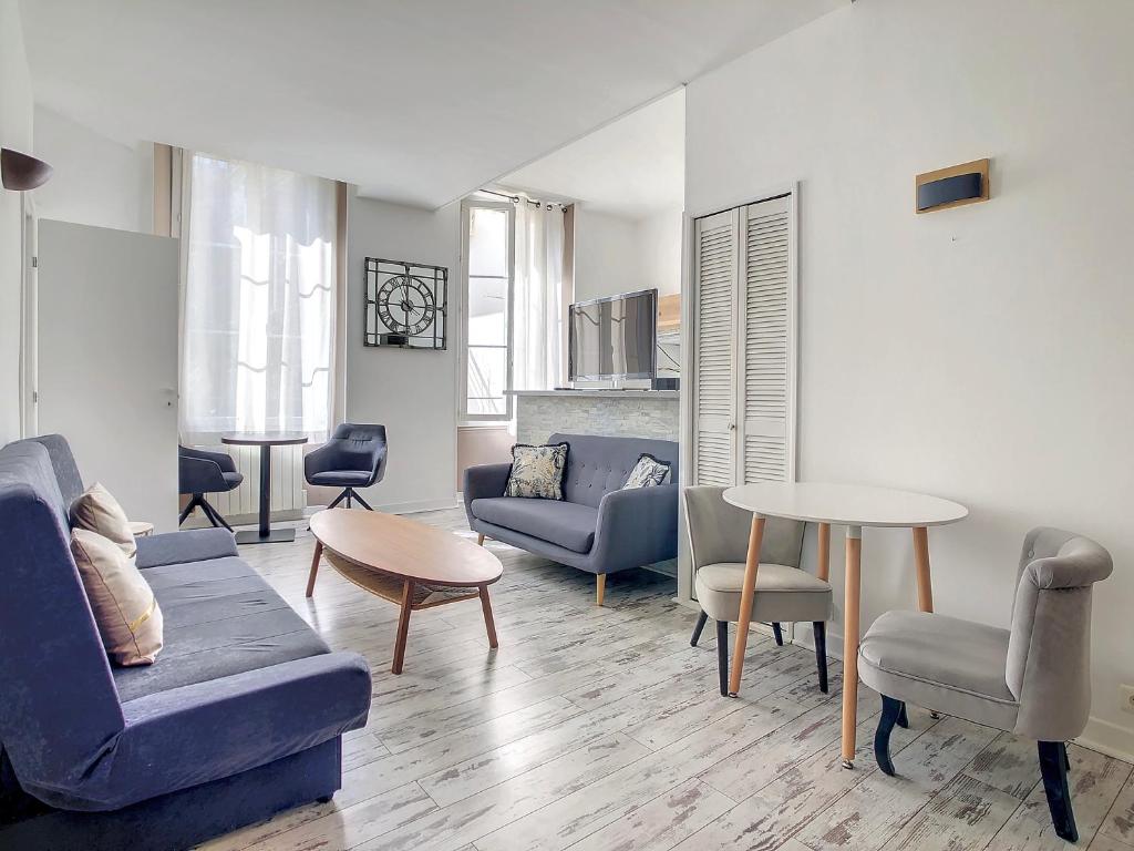 a living room with a blue couch and a table at 2 Bedroom luxury flat Cannes Center La Croisette in Cannes