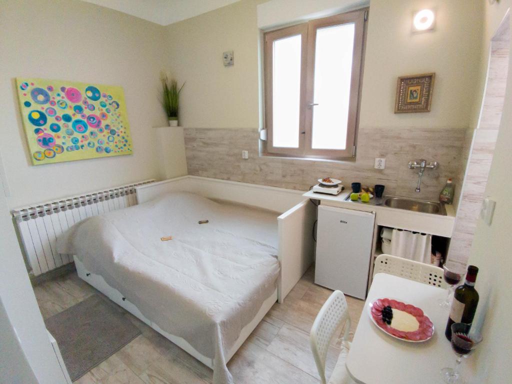 a small room with a bed and a sink at HAPPY in Zagreb