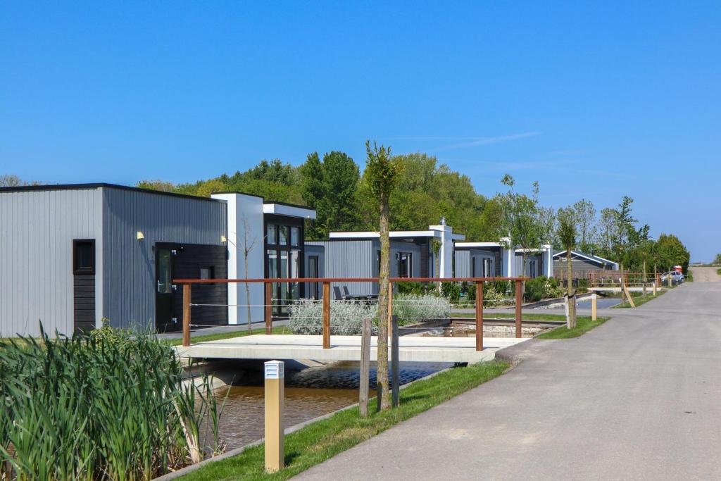 a row of modular homes next to a road at EuroParcs Bad Meersee in Nieuwvliet