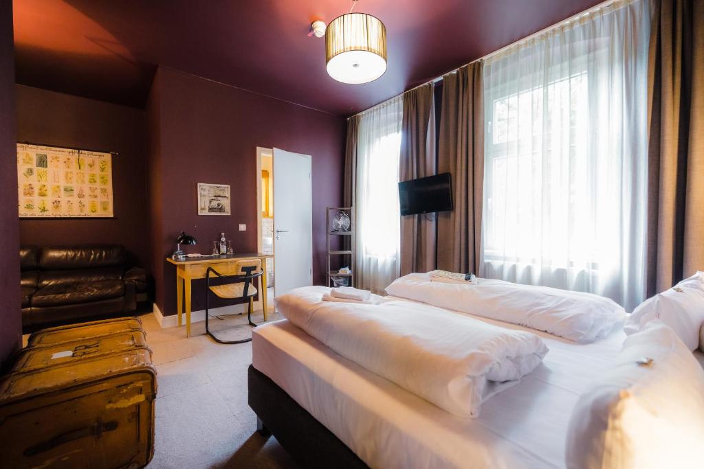 a hotel room with two beds and a window at Hotel Luis in Regensburg
