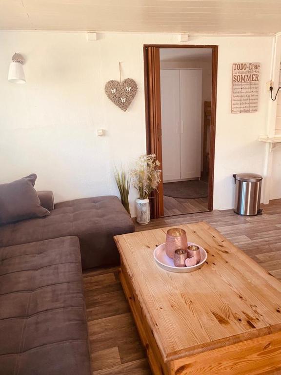 a living room with a couch and a table at Bungalow "Strandblick" in Göhren