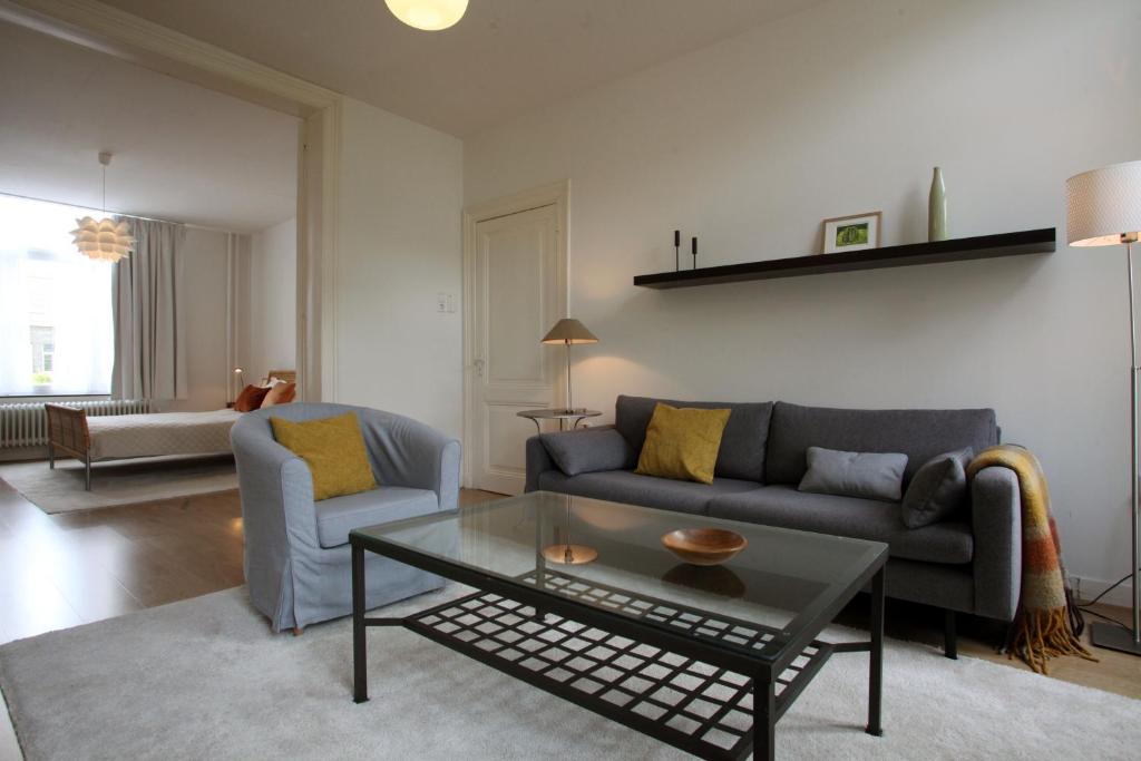 a living room with a couch and a coffee table at B&B Alexander in Maastricht