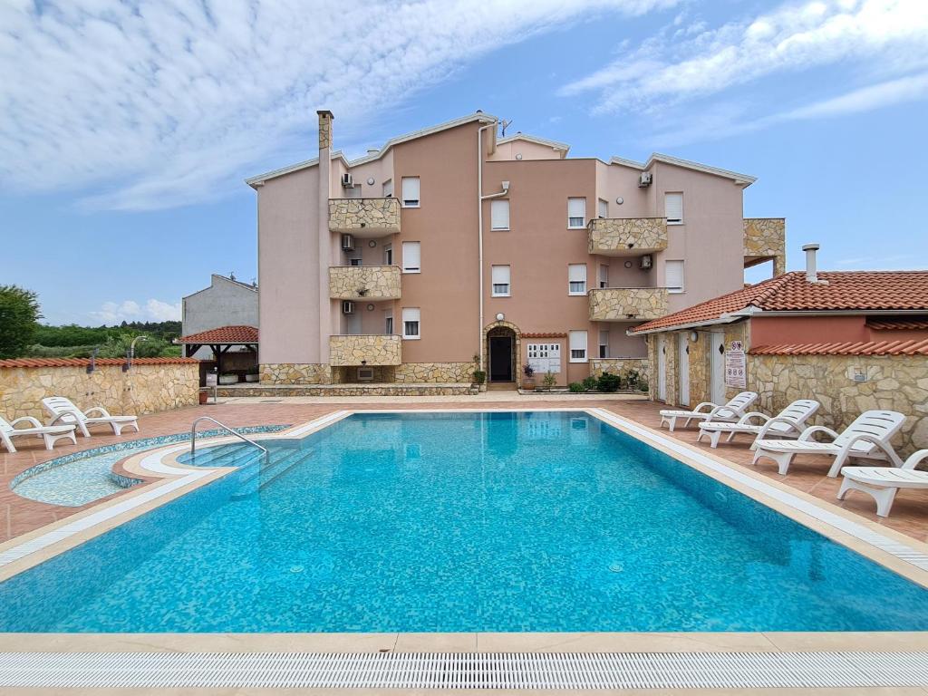 a large swimming pool in front of a building at Villa Bonaca in Umag