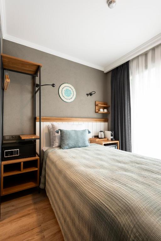 A bed or beds in a room at Istanbul Old City Colorful Houses Balat PETRION Hotel