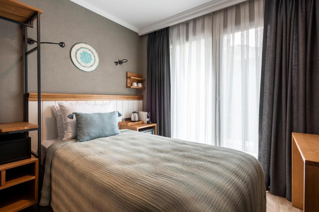 A bed or beds in a room at Istanbul Old City Colorful Houses Balat PETRION Hotel
