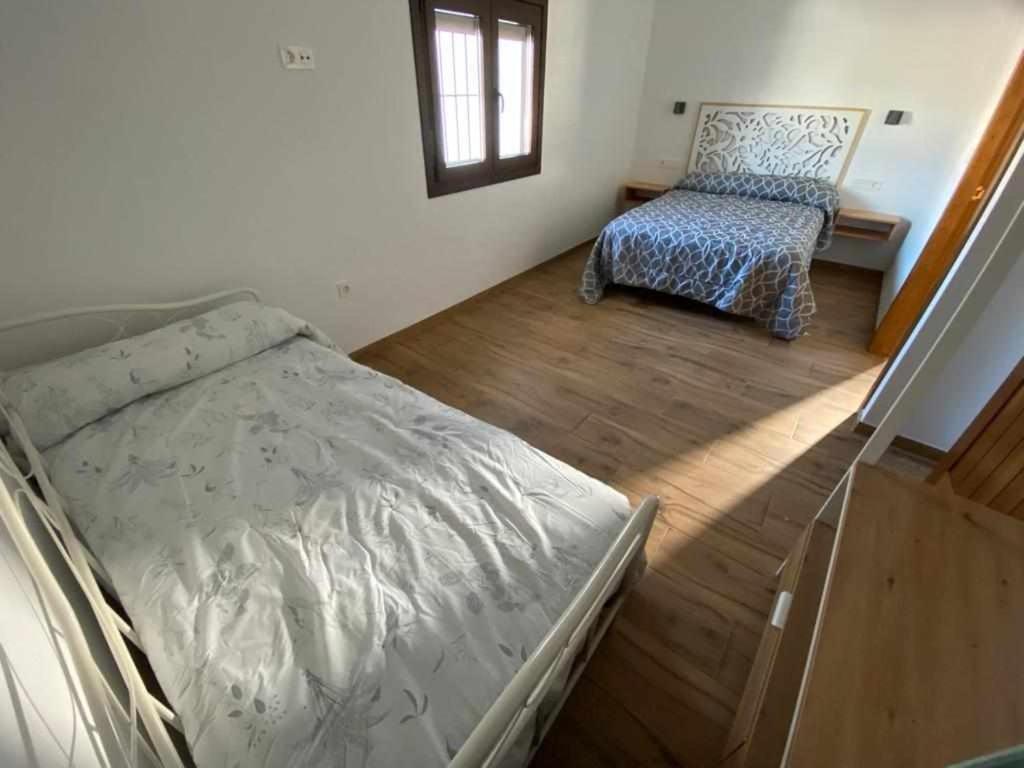 Postel nebo postele na pokoji v ubytování El cortijo del abuelo pepe