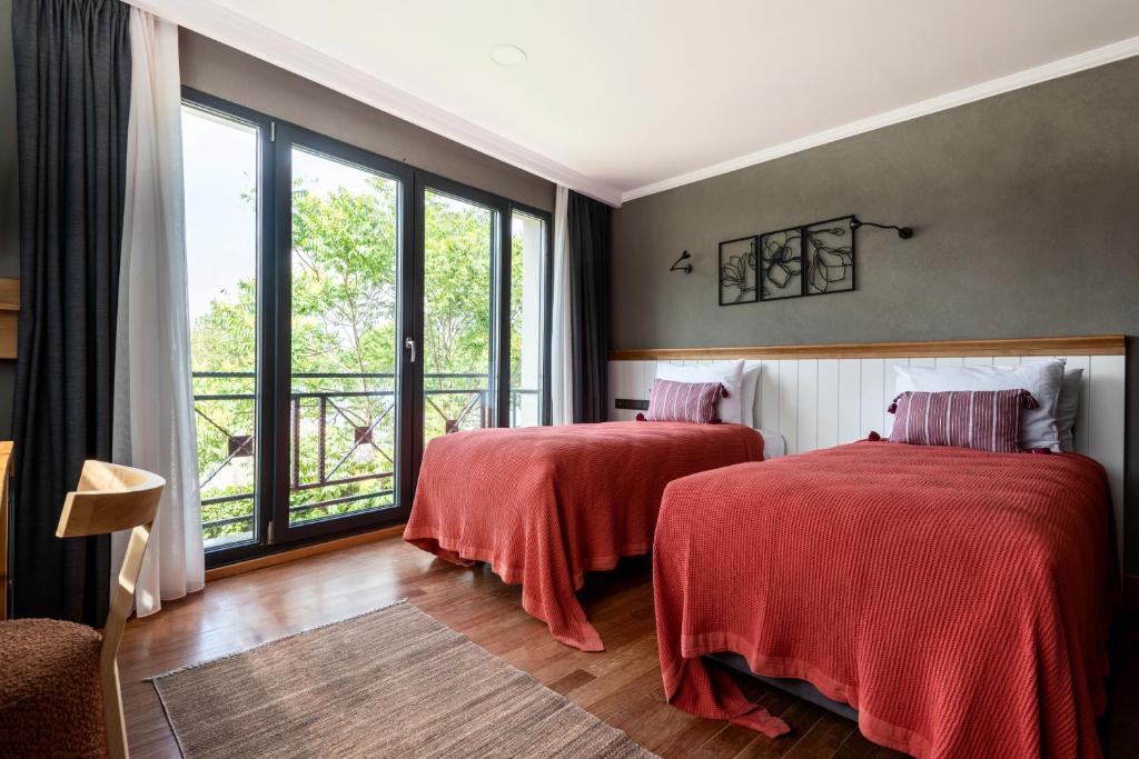 A bed or beds in a room at Istanbul Old City Colorful Houses Balat PETRION Hotel