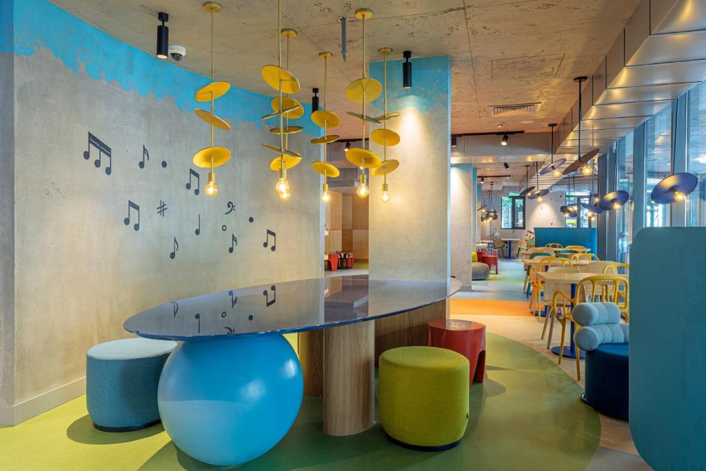 a conference room with a table and chairs and music notes on the wall at ibis budget Tbilisi Center in Tbilisi City