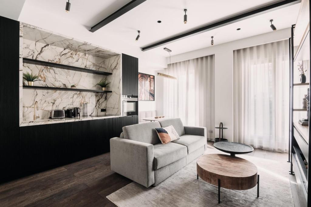 a living room with a couch and a table at HIGHSTAY - Luxury Serviced Apartments - North Marais 1 in Paris