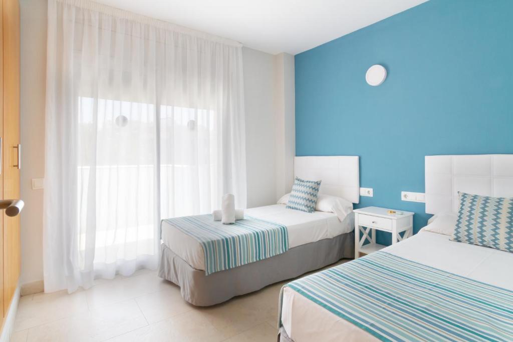 Postel nebo postele na pokoji v ubytování IBERSOL SPA AQQUARIA SUITES