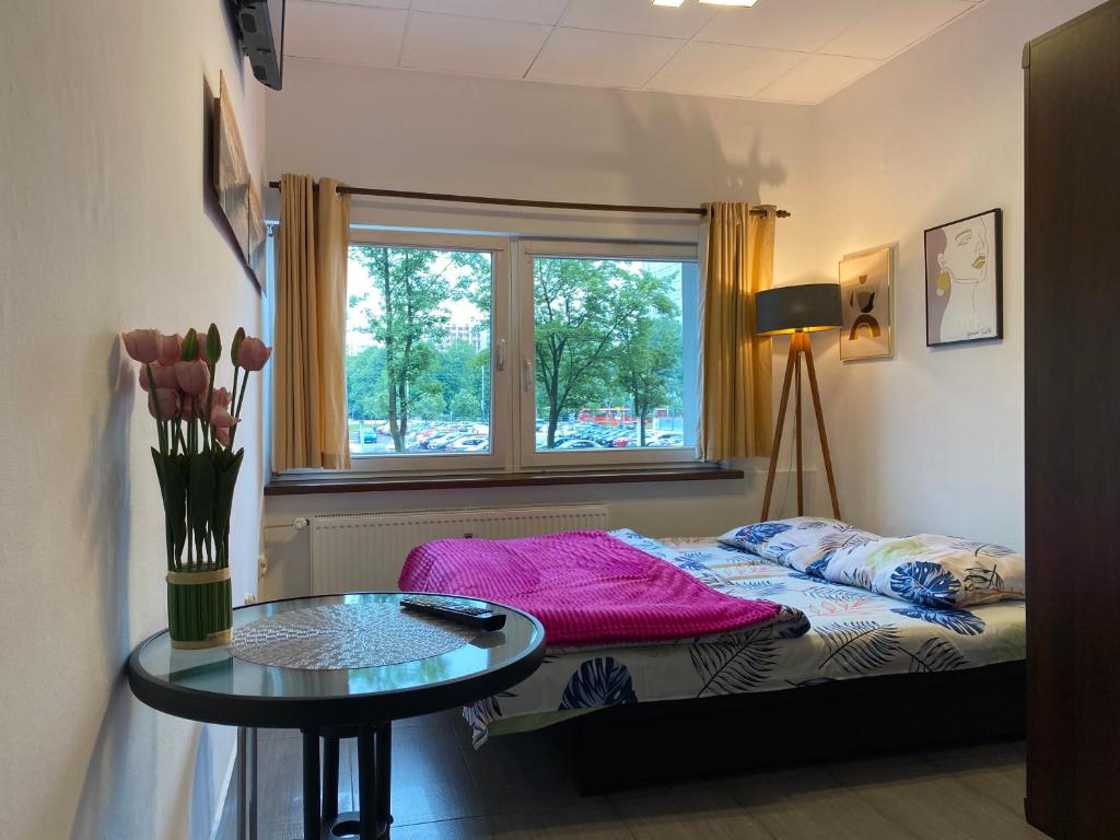 Posteľ alebo postele v izbe v ubytovaní Aparthotel Superjednostka Katowice