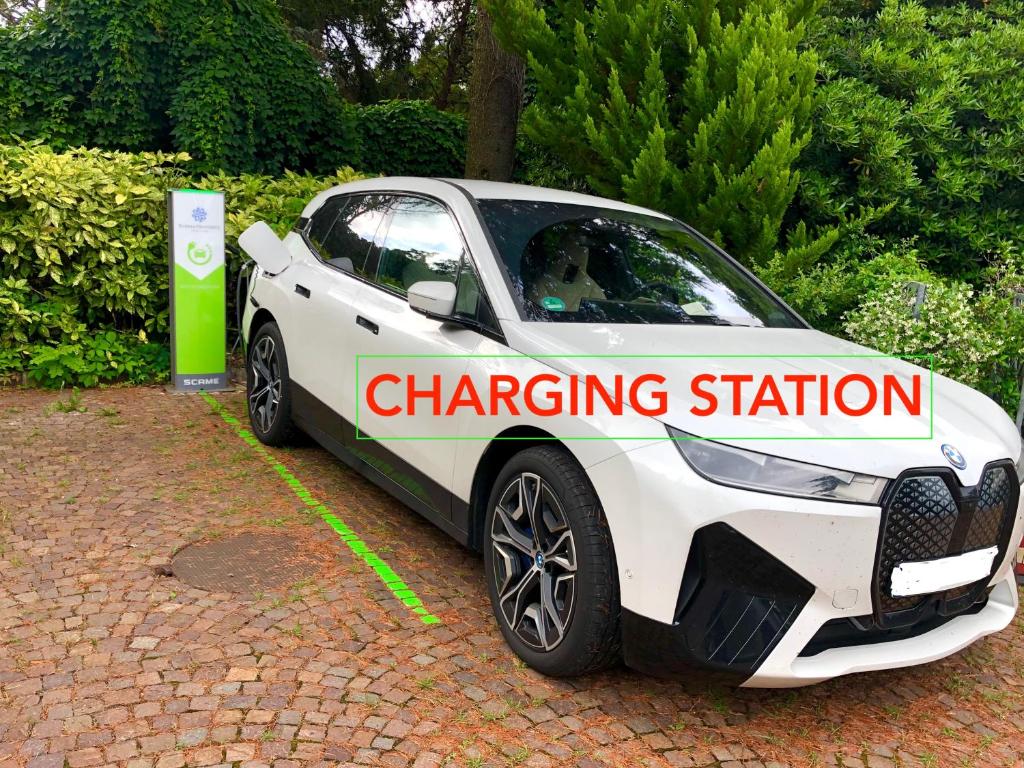 a white car parked in a charging station at Hotel Riviera & Maximilian's in Trieste