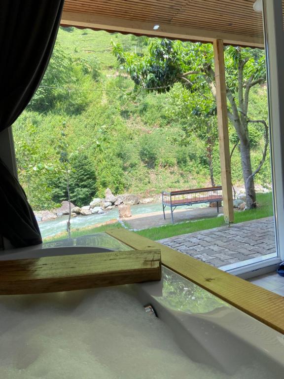 a window with a view of a park with a bench at Karadeniz Suit in Rize