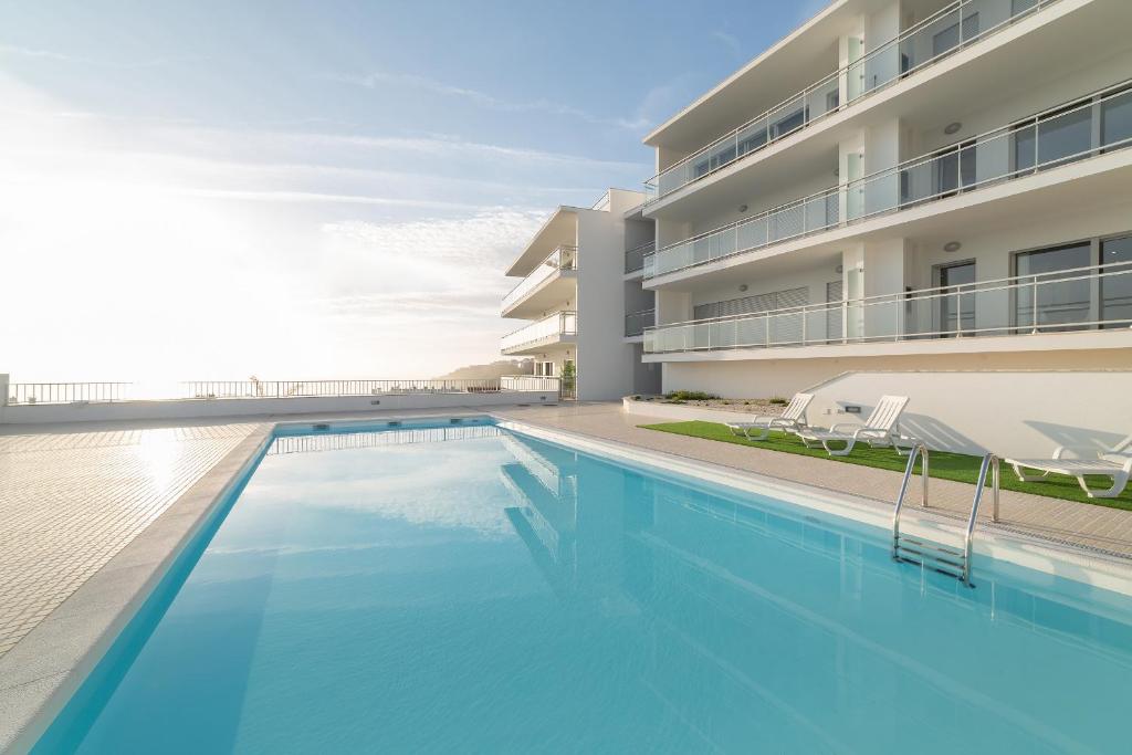 a swimming pool in front of a building at Sunset Views - By SCH in Nazaré