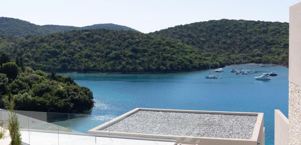 a view of a river with boats in the water at Sivota Deamaris Luxury Boutique Hotel in Syvota