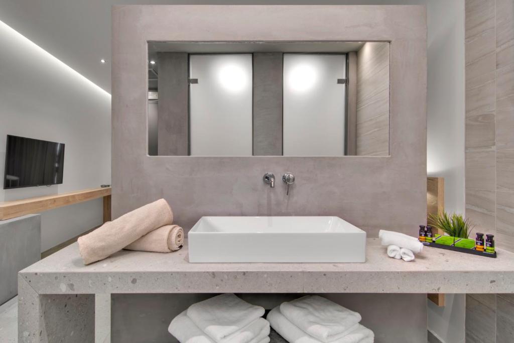 a bathroom with a sink and a mirror at Sivota Deamaris Luxury Boutique Hotel in Syvota