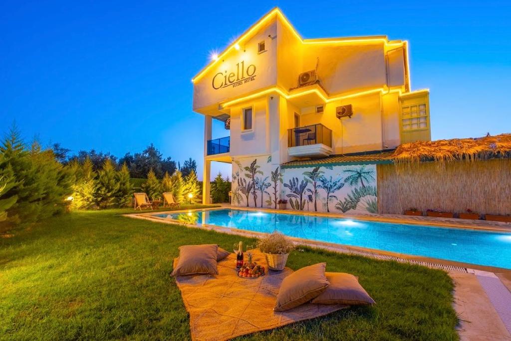 a villa with a swimming pool in the yard at Ciello Suites Hotel in Fethiye