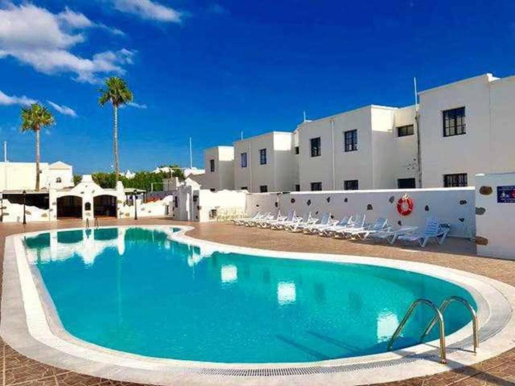 a large swimming pool in front of a building at Blue Ocean in Puerto del Carmen