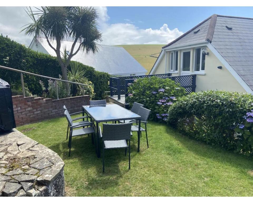 a table and chairs in the yard of a house at Higher Upover in Woolacombe
