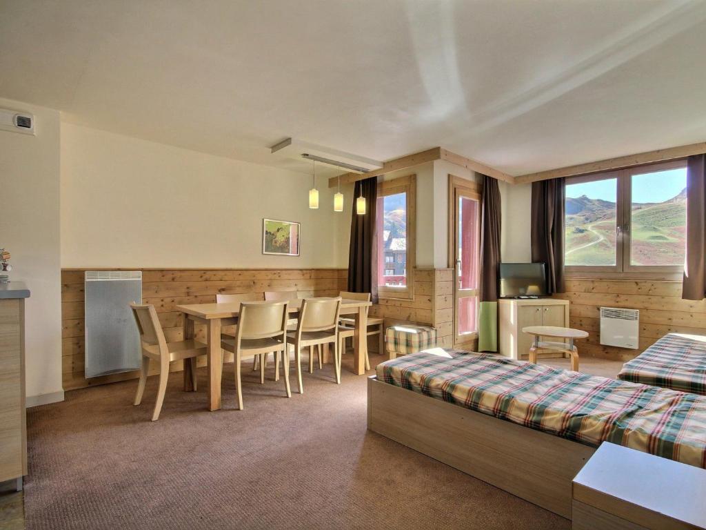 une chambre avec un lit, une table et des chaises dans l'établissement Duplex moderne proche pistes, balcon, cuisine équipée, pour 7 pers - FR-1-455-181, à La Plagne Tarentaise