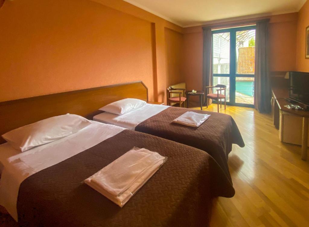 Postel nebo postele na pokoji v ubytování Batesta Hotel