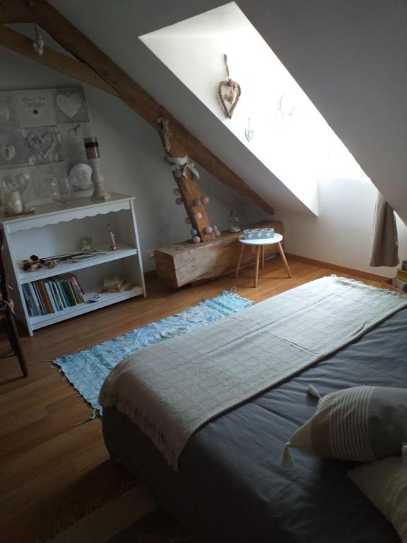 a bedroom with a large bed in a attic at Chambres d'hôtes, " au coeur de la nature, et du calme" in Descartes