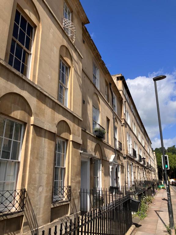 a row of buildings on the side of a street at Elegant well appointed maisonette 105m2 in Bath