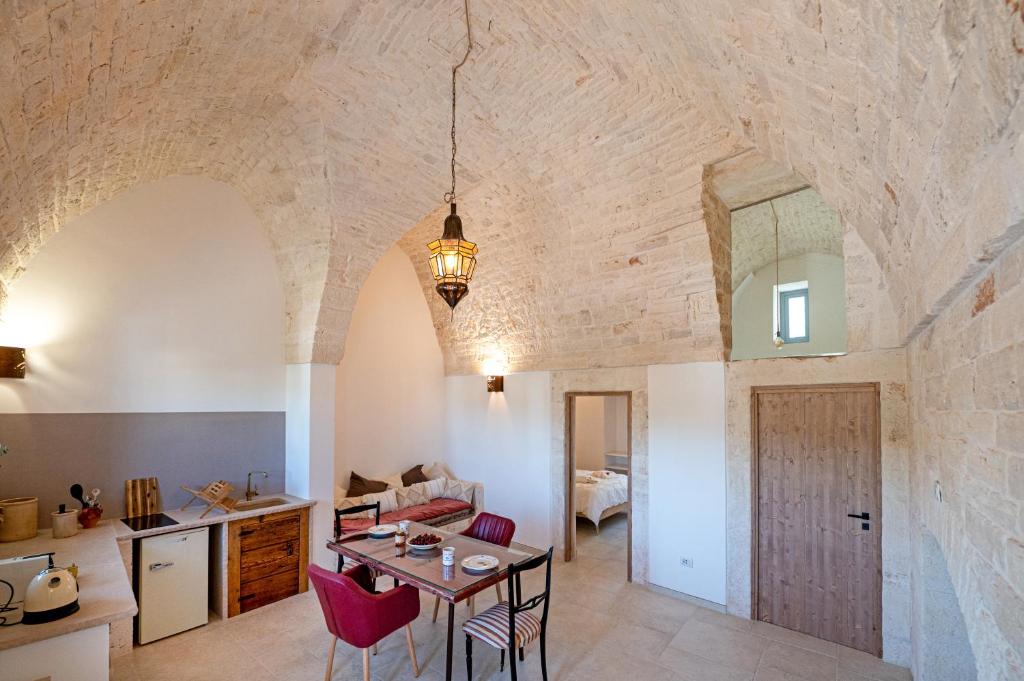 阿爾貝羅貝洛的住宿－Lamia Mari'- Aia Piccola，厨房以及带桌椅的起居室。