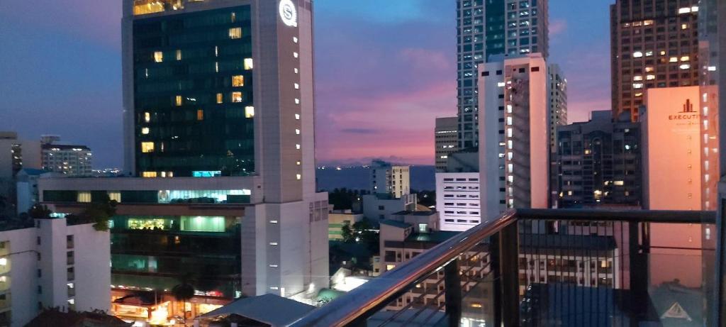 a view of a city at night with a clock tower at One Bedroom Condo With Pool in Manila