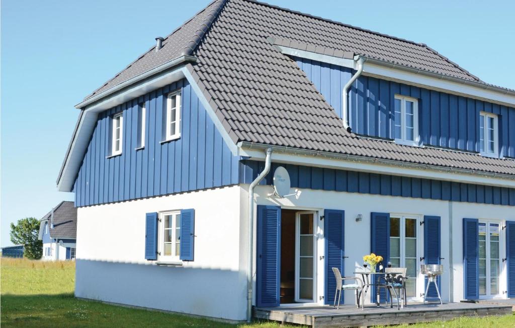 a blue and white house with a porch at Ferienhaus 3 Altefähr in Altefähr