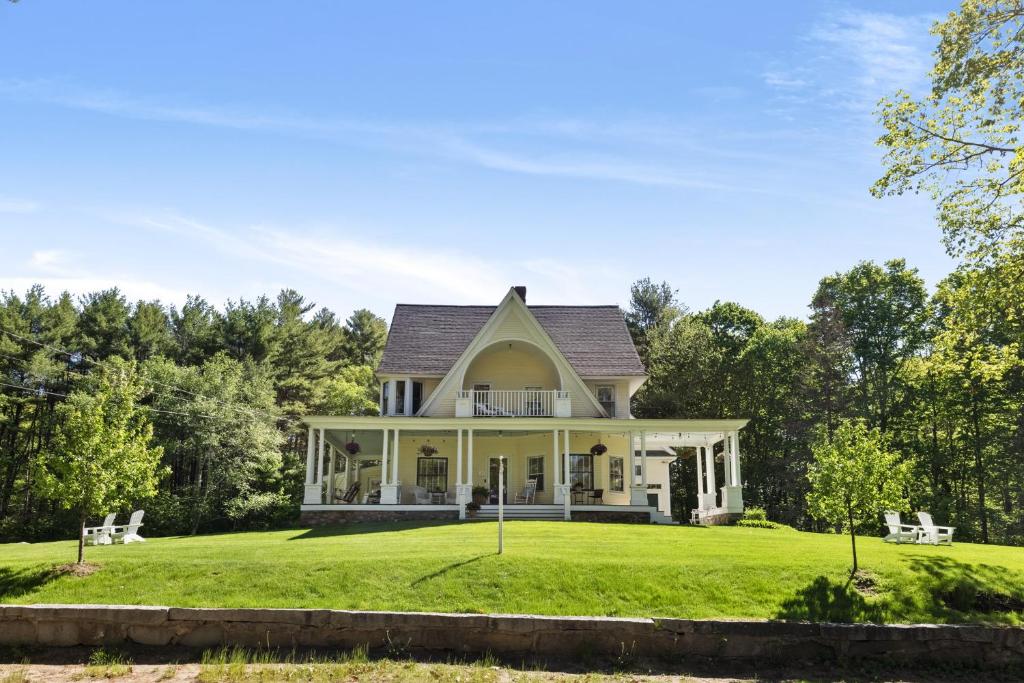 a house with a large yard with green grass at Noble House Inn in Bridgton
