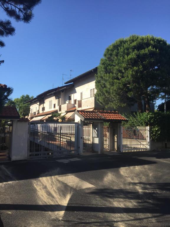 a white fence in front of a building at Casa ARCOBALENO in Cornaredo