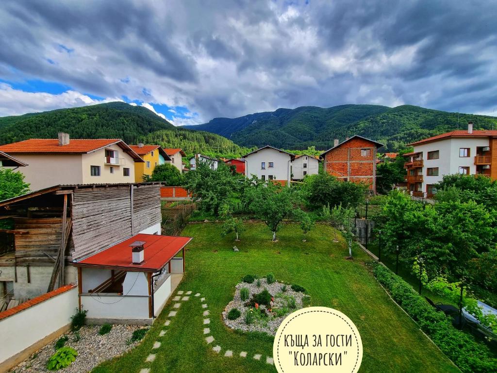 薩帕雷瓦巴尼亞的住宿－Къща за гости Коларски，享有带房屋和山脉的庭院的景色