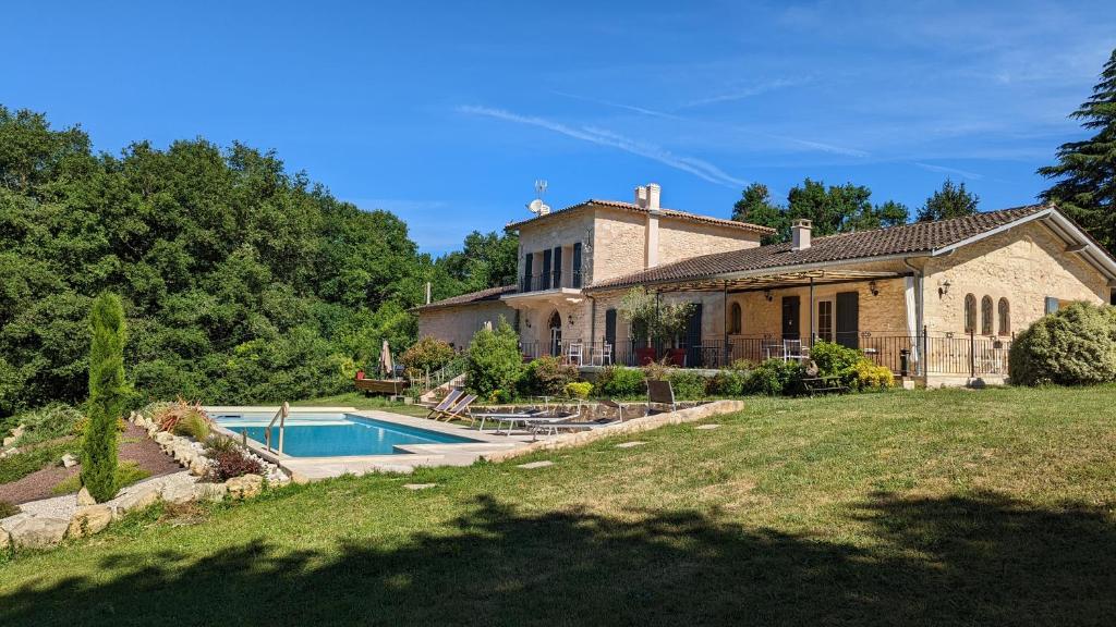 une maison avec une piscine en face de celle-ci dans l'établissement Domaine verte vallée, à Lignan-de-Bordeaux