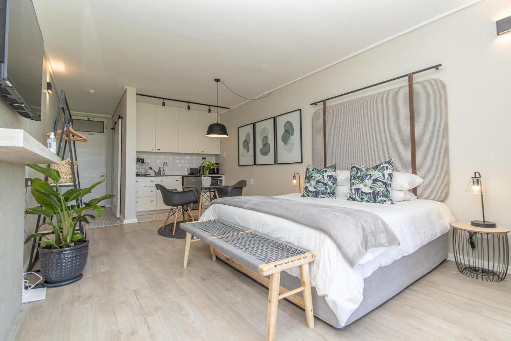 a bedroom with a large bed and a kitchen at 36 At Brookes in Summerstrand