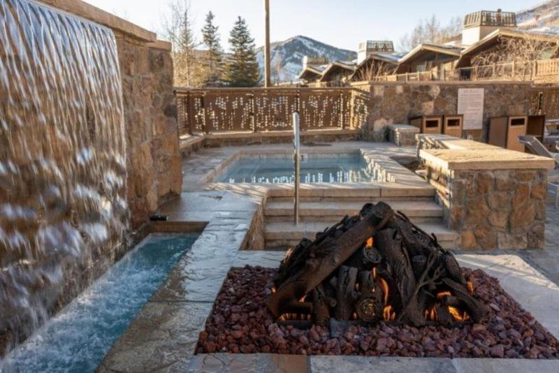 a swimming pool with a fire pit in a yard at Slopeside 2 Bedroom Gold-rated Residence At Golden Peak In Vail Village in Vail