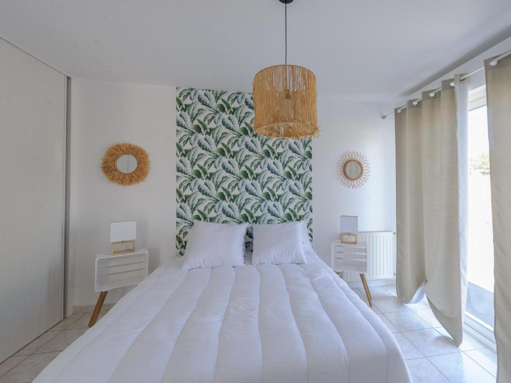 a bedroom with a large white bed and a large window at Appartement La Jarne, 2 pièces, 4 personnes - FR-1-535-35 in La Jarne