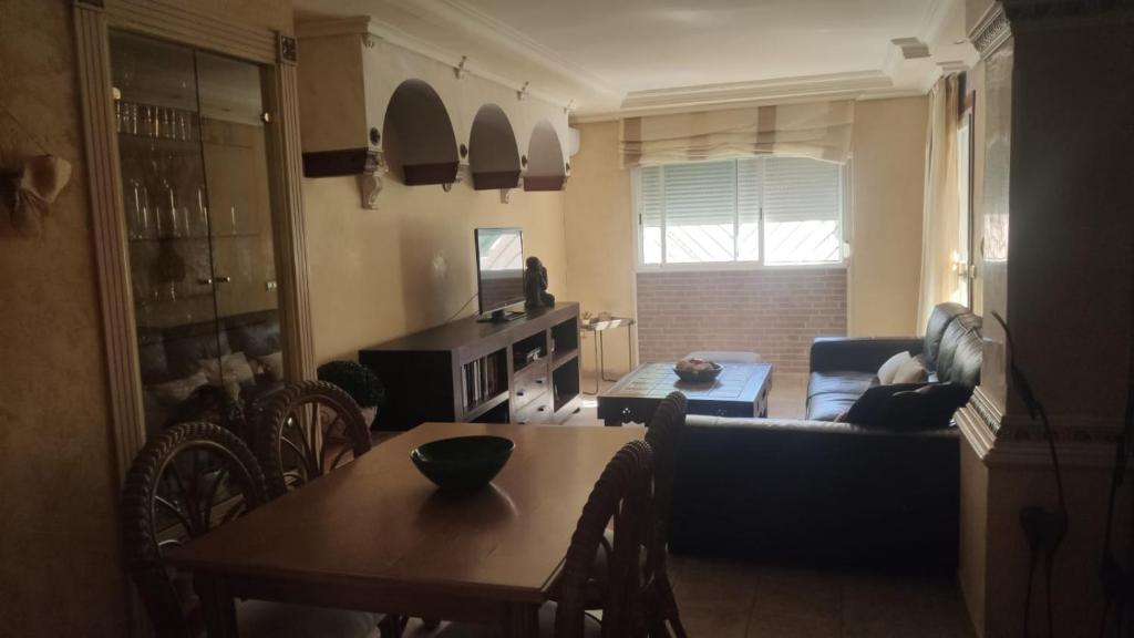 a living room with a table and a couch at Apartamento en Torremolinos in Torremolinos