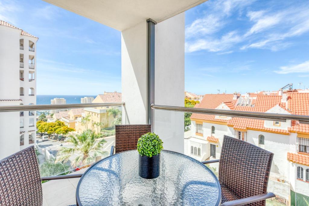 a table with a potted plant on a balcony with a view at Hanami Puerto Blanco (PB-23-3IZQ) in Estepona