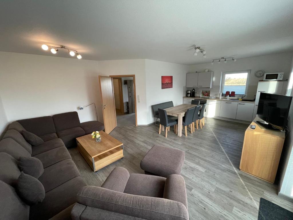 a living room with a couch and a table at Am Wangermeer 38 in Wangerland
