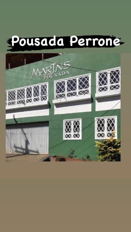 a green and white building with a sign on it at Pousada Perrone Antiga pousada Marins in Campos do Jordão