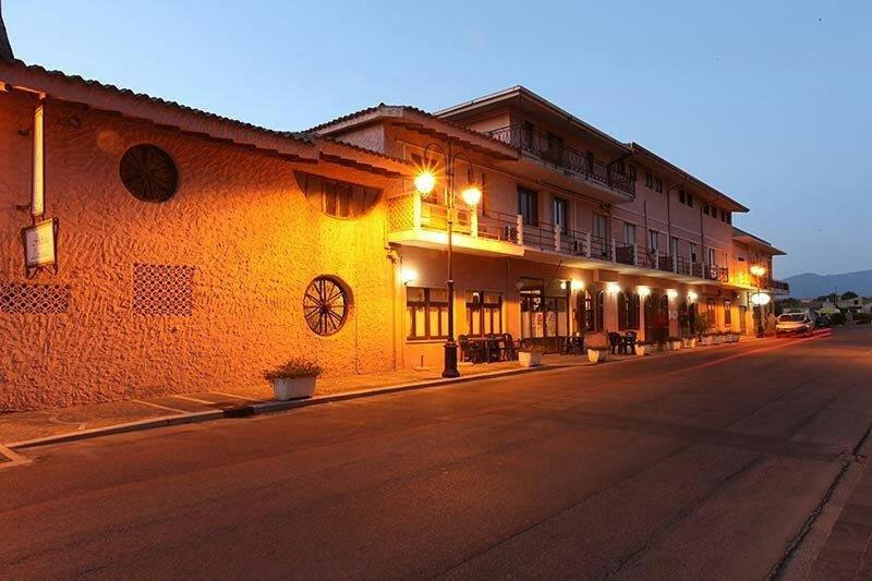 an empty street next to a building with lights at Locanda Rosella in Giba