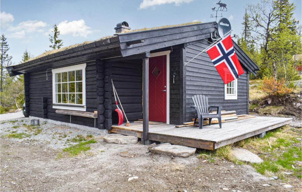 a tiny house with a flag on the porch at 2 Bedroom Gorgeous Home In Eggedal in Haglebu