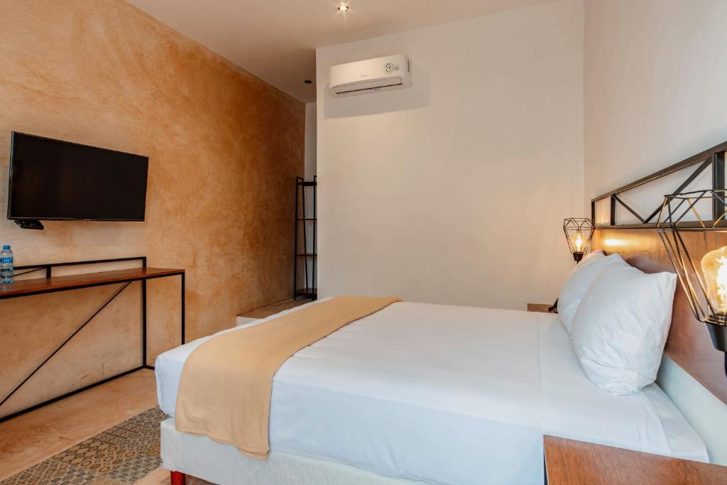 Postel nebo postele na pokoji v ubytování Hotel HO Merida