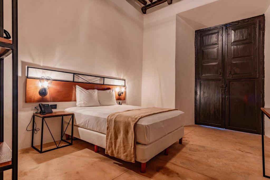 Postel nebo postele na pokoji v ubytování Hotel HO Merida