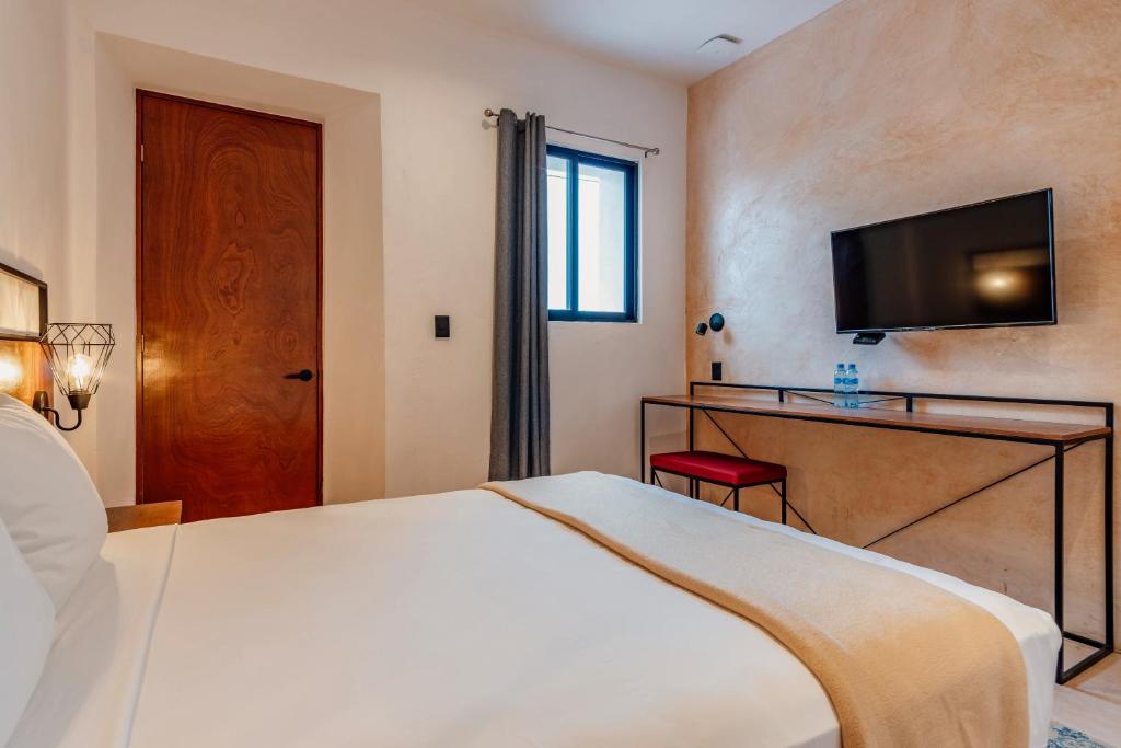 Postel nebo postele na pokoji v ubytování Hotel HO Merida