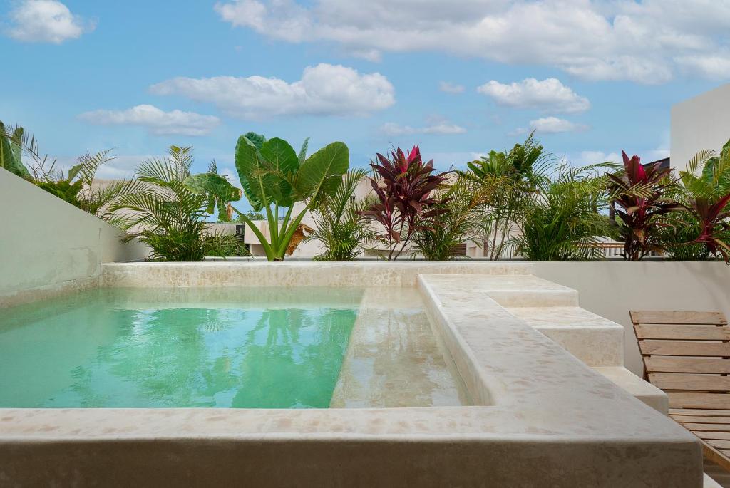 a swimming pool in the middle of a house at New Tulum Luxury 2BRBath with Private Pool Heart of La Veleta in Tulum