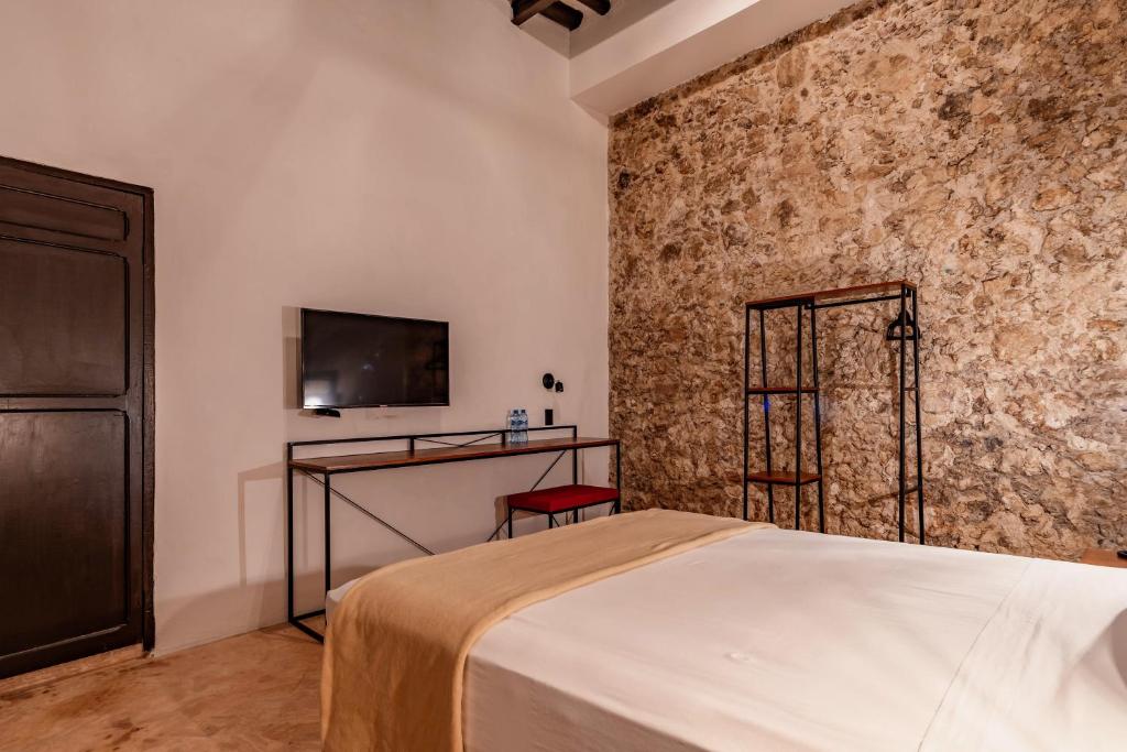 Postel nebo postele na pokoji v ubytování Hotel HO Merida