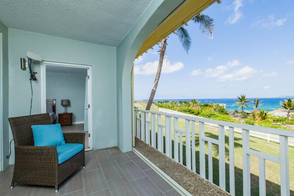 a balcony with a view of the ocean at Dramatic views from this specious 1bd/1bth in Christiansted