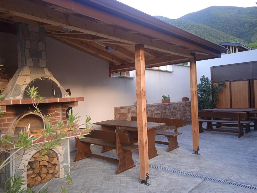 a patio with a picnic table and a pizza oven at Семеен хотел При Вергил in Sapareva Banya